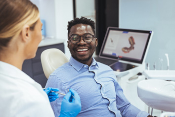 Patient smiling at dentist in treatment room