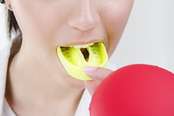 a woman wearing an athletic mouthguard