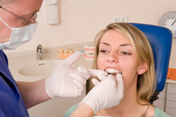 Female patient having Invisalign aligner placed over teeth