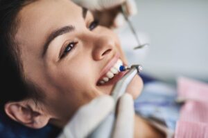Patient getting her teeth polished in dental office 