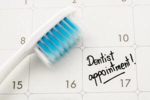 a calendar with a reminder for a dental appointment written on it
