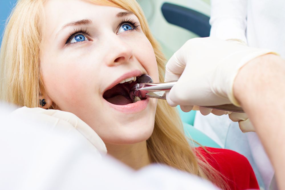 A woman having her tooth extracted